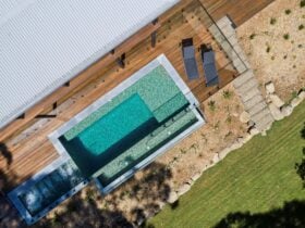 Sun-soaked expansive deck surrounding pool and spa with sun lounges and outdoor living