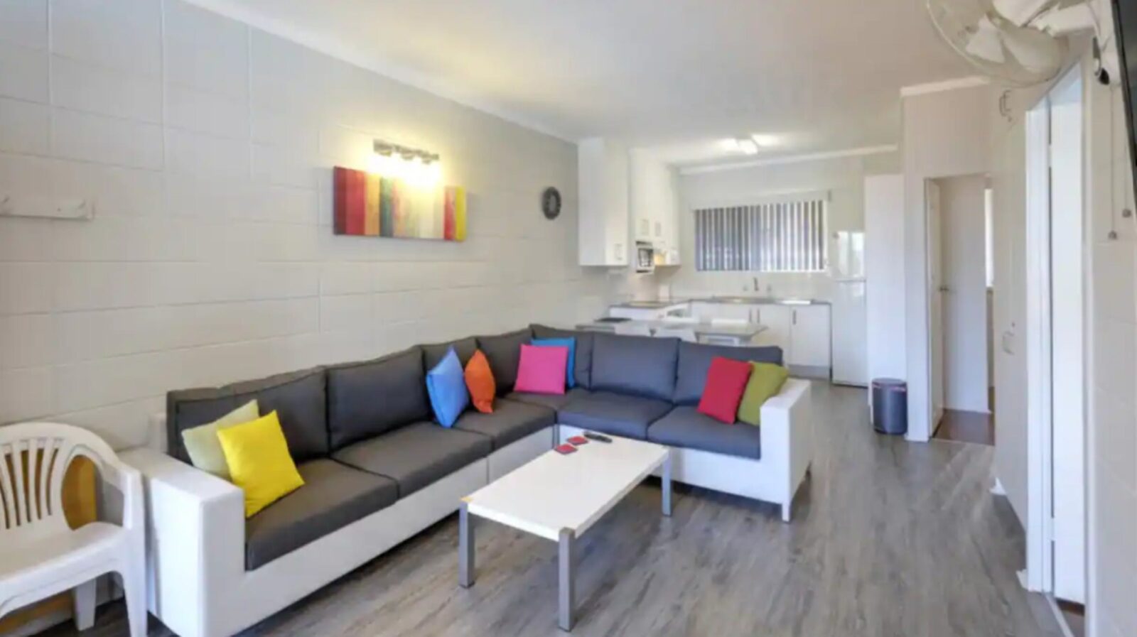 Living area with spacious lounge, kitchen with breakfast bar and stools