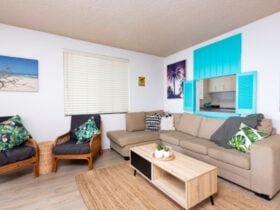 Living room with decorative blue shutters and coastal decor