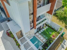 Aerial view of holiday home including balcony, pool and garden