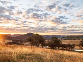 Wide shot of Kundalini Lodge and surrounding countryside at sunset