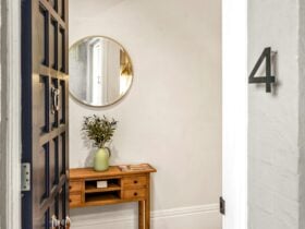 front door, round mirror, hall stand, flowers