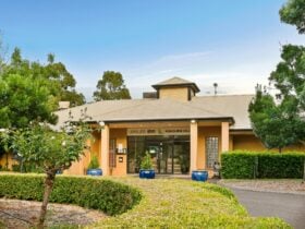Entrance of Leisure Inn Pokolbin Hill with signage and landscaped gardens
