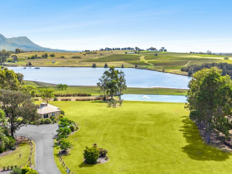 Scenic vineyard landscape with lake and rolling hills in Pokolbin