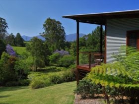 Cabin sited with a view of the mountains beyond