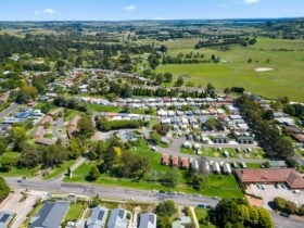 Aerial view of the Park showcasing a well-organized layout of cabins, homes, & green space.