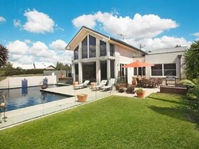 Play A Round outdoor area including pool and dining area