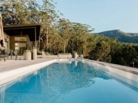 Image of the pool situated on the deck. BBQ and outdoor furniture is on the deck - Bush backdrop