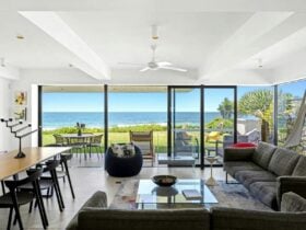 Open plan dining, living, and kitchen area with seamless flow to outdoor views