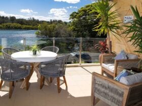 Balcony with dining setting and unobstructed lake views