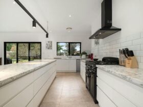 Large kitchen and island full of amenities and appliances