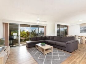 Living room, leading out to furnished balcony