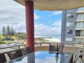 Balcony with beach views and dining setting