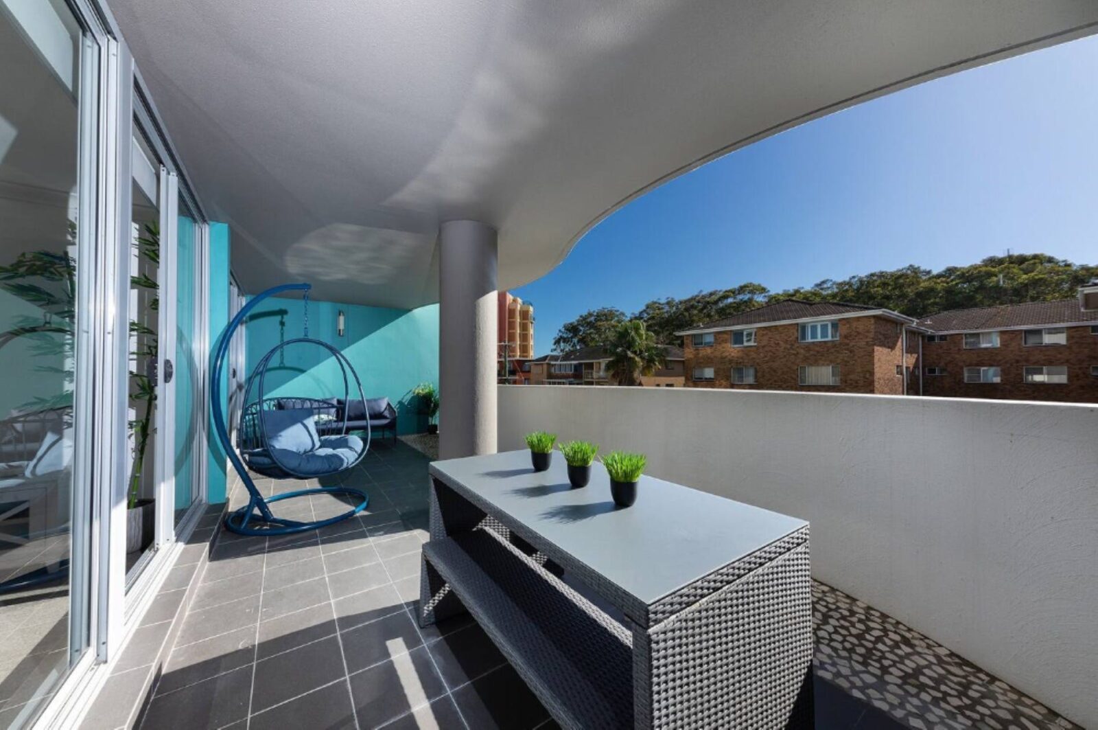 Balcony with egg chair and high table setting