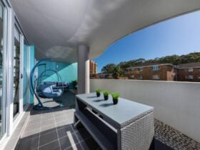 Balcony with egg chair and high table setting