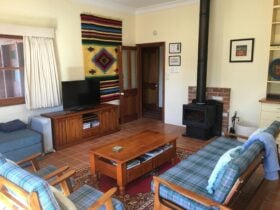 Photo of the lounge, Flatscreen TV, slow combustion fireplace