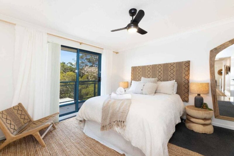 Master bedroom with Queen bed, ceiling fan and statement bed head