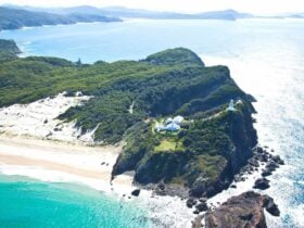 Exquisite aerial of Sugarloaf Point with keepers' cottages, lighthouse ... looking north