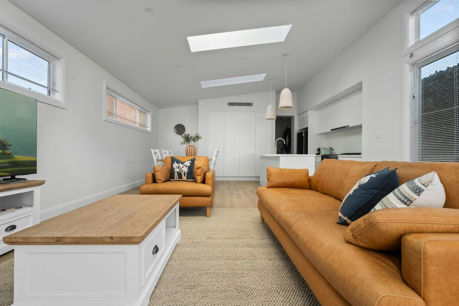 Large 3 seater couch, armchair, coffee table, smart tv, large kitchen & dining area.