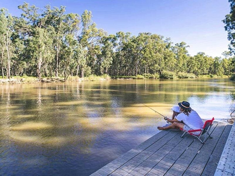 Father and daughter fishing from a deck, Swifts Creek campground, Murray River National Park. Photo: