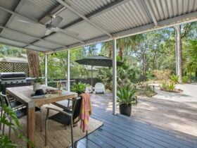 Deck with umbrella, seating, lounge and BBQ
