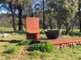 Outdoor bath on deck in paddock amongst trees