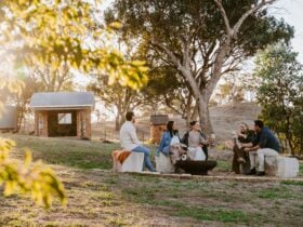 Five adults enjoying a wine around the firepit