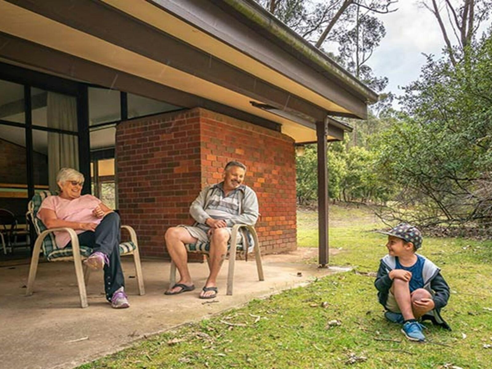 Family sitting outside Wombeyan Caves dormitories. Photo: OEH/John Spencer
