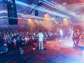 act on stage performing to crowd