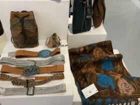 Photo of inside the gallery, showing handmade leather beltas and hand-felted wooolen scarf