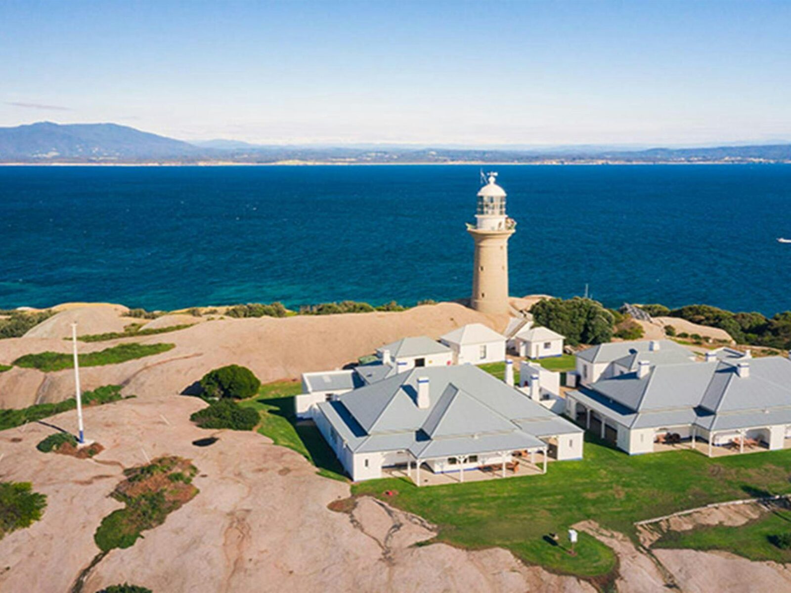 Aerial view of Montague Island Lighthouse and cottages, and views to the mainland. Photo: Daniel