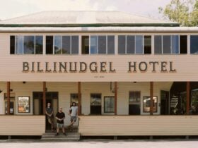 front view of historic traditional Australian pub with owners standing on the steps