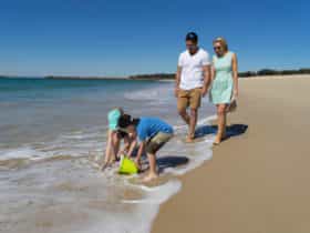 Family walking on Blacksmiths Beach