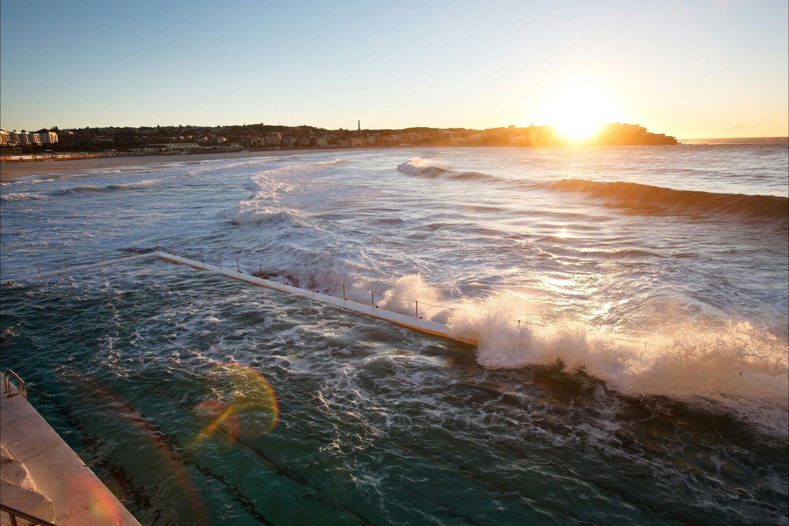 Sunrise at Bondi Beach with Bondi ocean pool in foreground. View from Bondi Icebergs Club