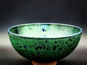 Bowl, made on the potters wheel and finished in a green glaze with glassy blue spots.
