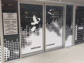 Welcome everyone sign on Library Doors with white decorations