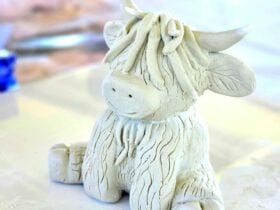 Sitting Clay Highland Cow