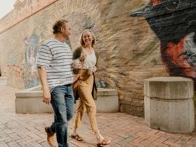 couple walking past native animal mural