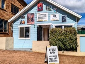 Light blue Dorrigo Photographic Services shop front with gallery wall of local prints