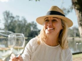 Lady drinking wine in the sunshine outside