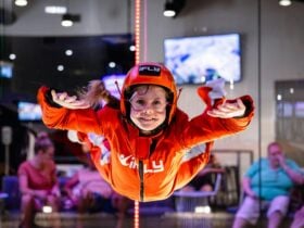 Young girl in an orange suit flies solo.