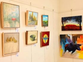 Several paintings hanging on a wall.