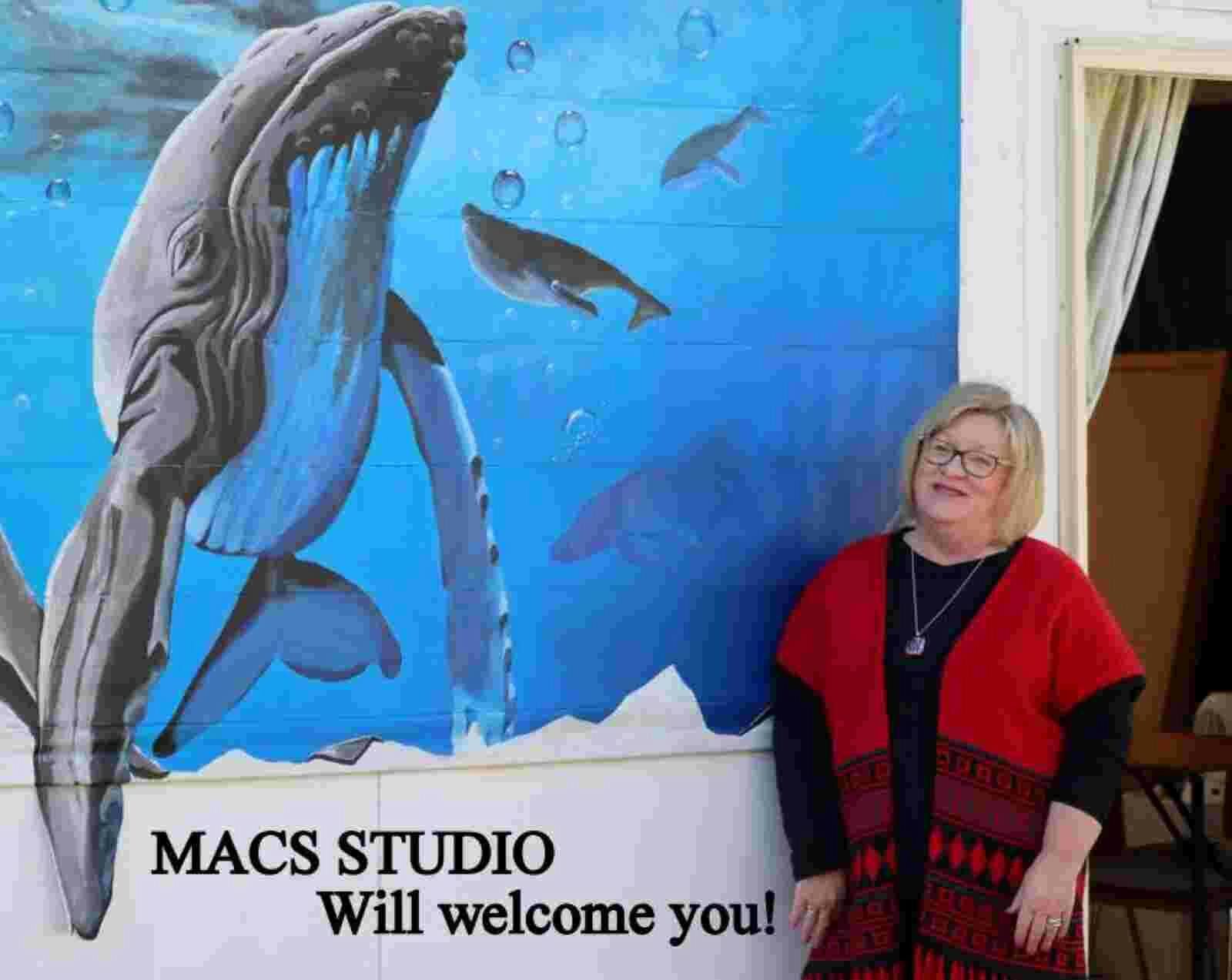 Mural on the wall at the MAS Studio, featuring whales and a smiling woman welcoming you