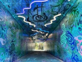 A tunnel with artwork and lighting