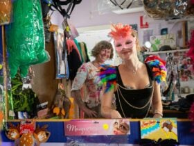 Girl trying on party supplies and dress ups