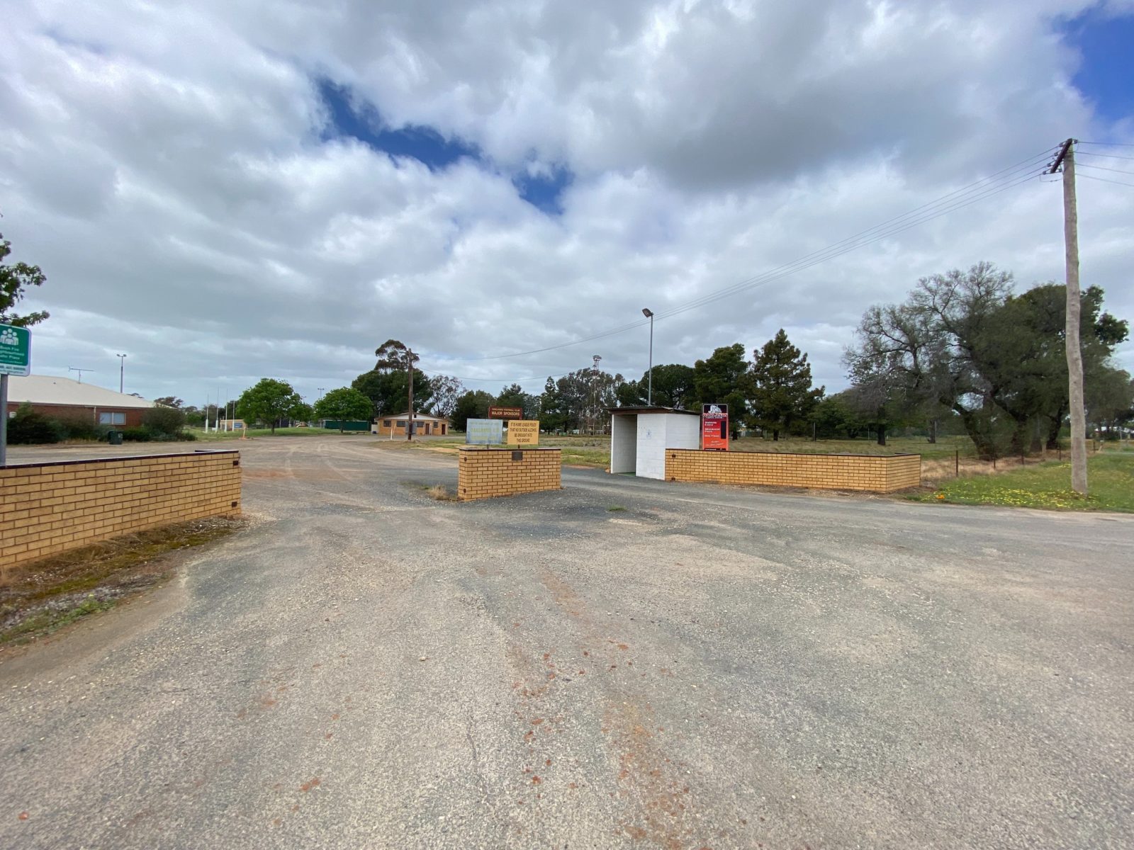 The brick entrance to the Oaklands Recreation Reserve, with amenities buildings in the background.