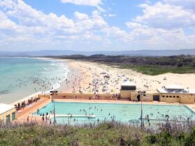 pool and beach with people swimming