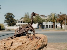 A scrap metal goanna perches atop a rock in Urana.
