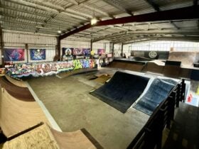 Indoor skatepark with ramps, graffiti walls, and ridersâ area at Slam Factory Tuggerah.