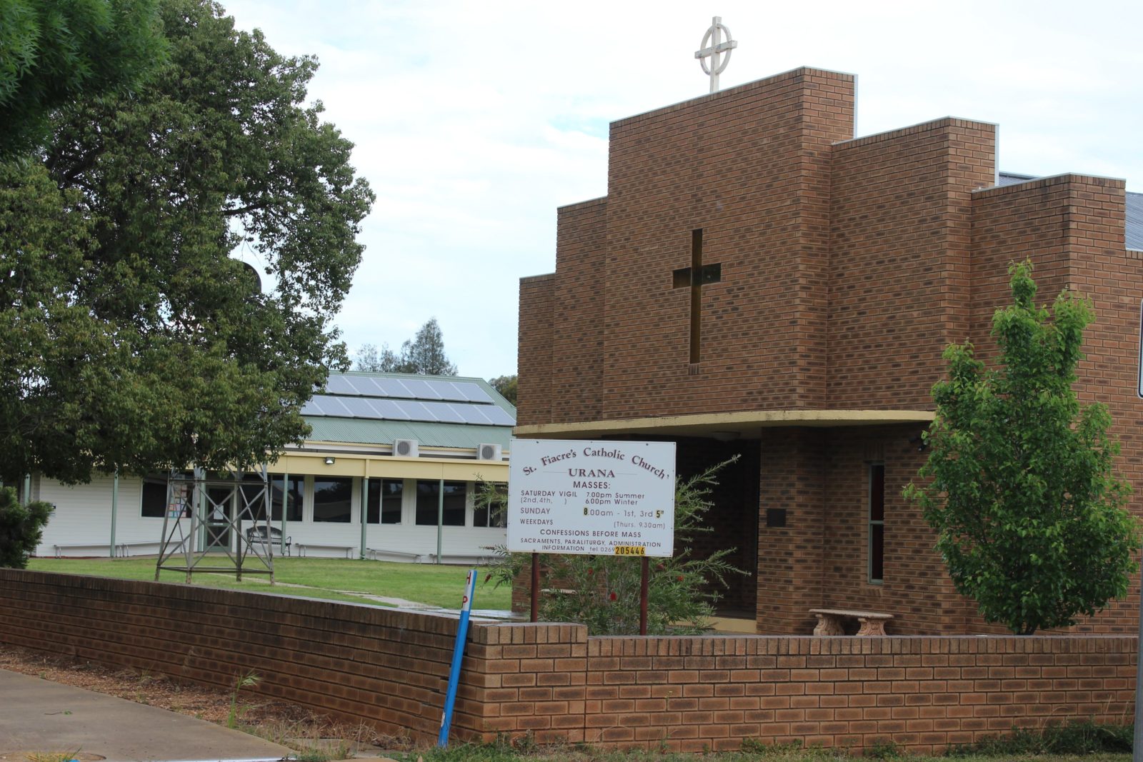 The brick fence and building of St Fiacres Roman Catholic Church in Urana.